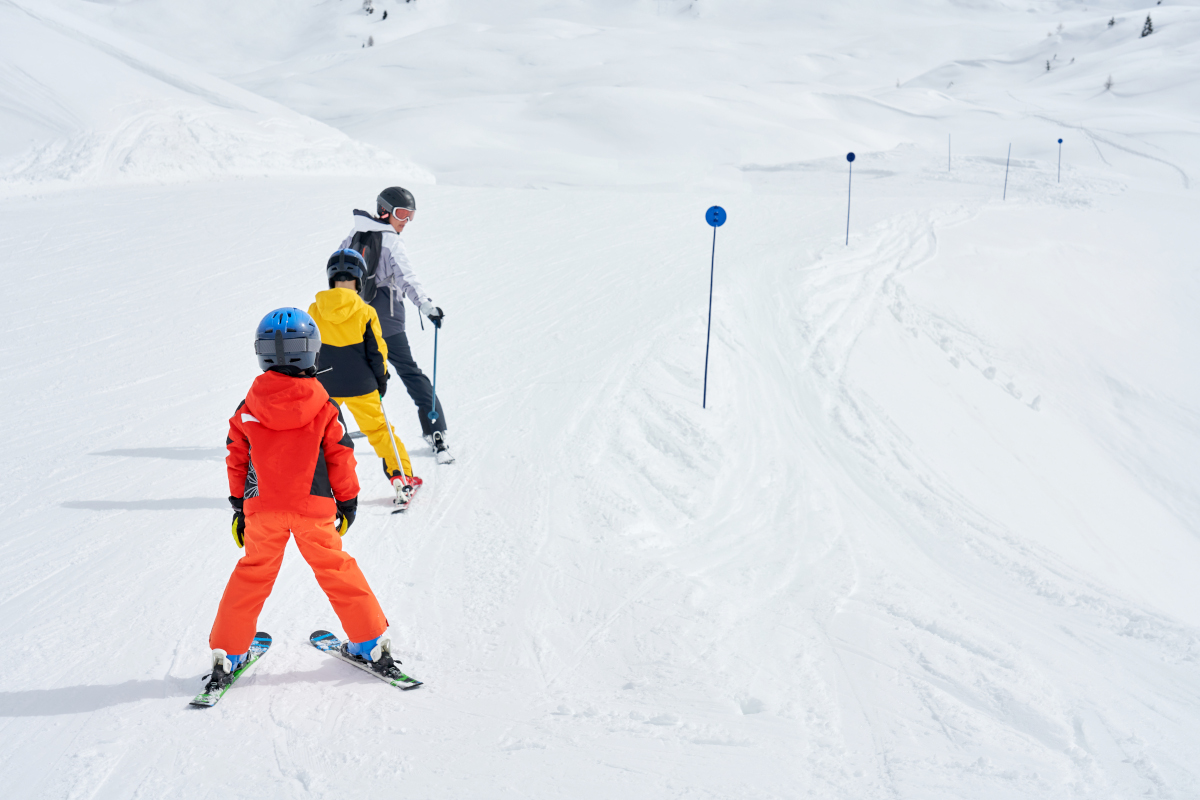 Picture of mother teach skiing her kids in Madonna di Campiglio
